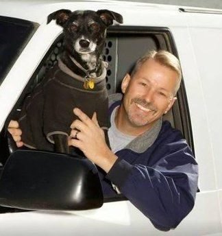 Dean Sperlin, owner and operator of Lightning Lock and Key, with his dog